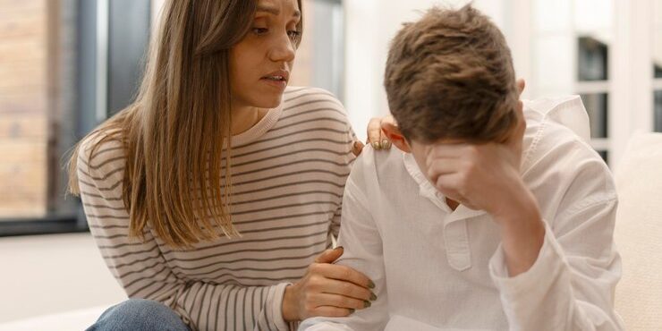 mother-comforting-her-sad-teenage-son-home_695242-25491