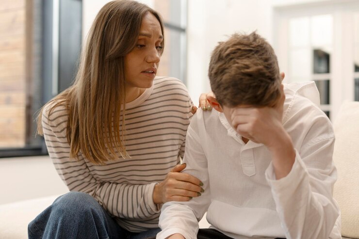 mother-comforting-her-sad-teenage-son-home_695242-25491