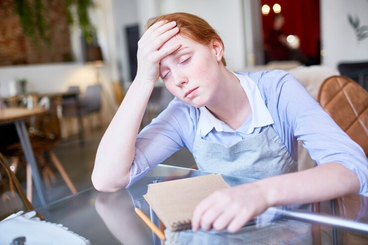 exhausted-waitress-suffering-from-headache_1098-15058