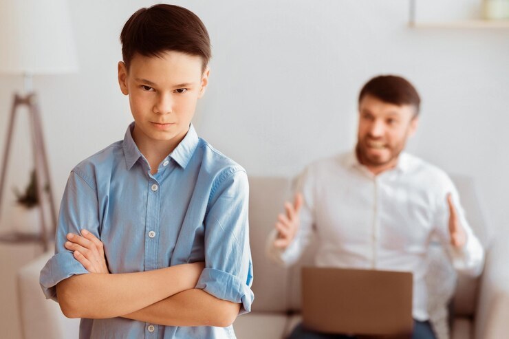 furious-father-shouting-son-sitting-sofa-home_922936-58246