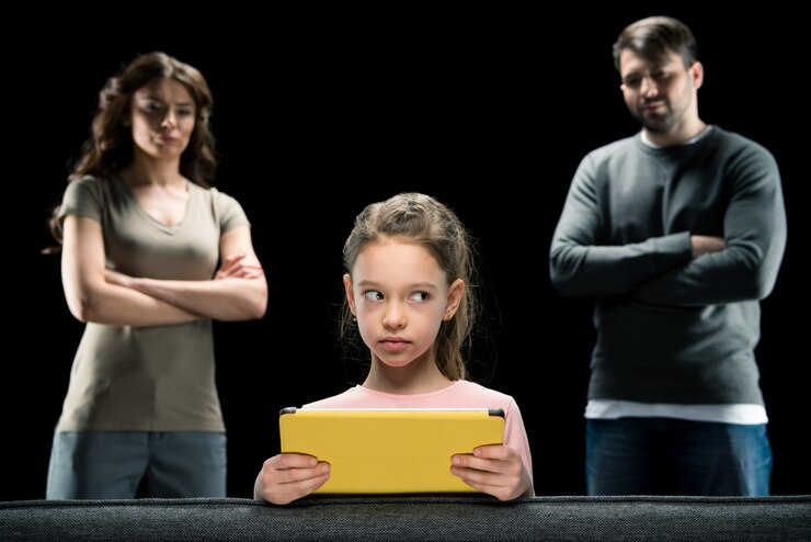 girl-using-digital-tablet-while-parents-standing-with-crossed-arms-black_126050-1