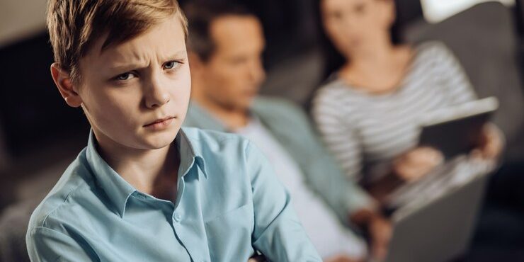 need-your-love-sad-pre-teen-boy-looking-disappointed-with-his-parents-paying-no-attention-him-while-sitting-sofa-working-their-gadgets_259150-26012