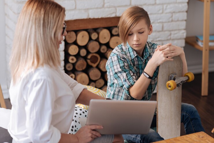 very-attentive-teenager-wearing-fitness-bracelet-right-hand-sitting-opposite-female-while-looking-downwards_259150-15901