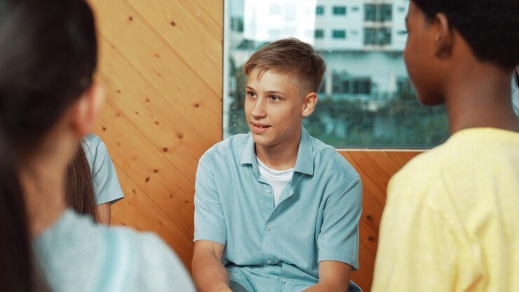 attractive-boy-sharing-experience-attend-group-therapy-edification_31965-299733