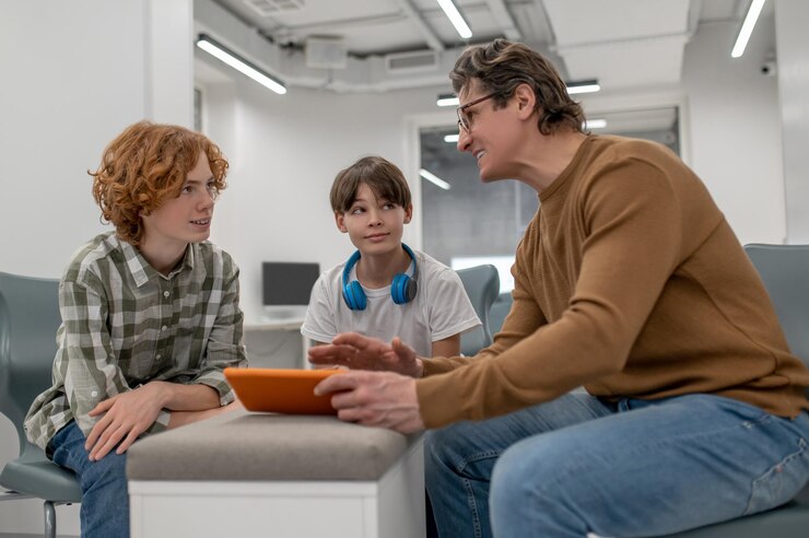 school-teacher-eyeglasses-explaining-something-his-students_259150-66217