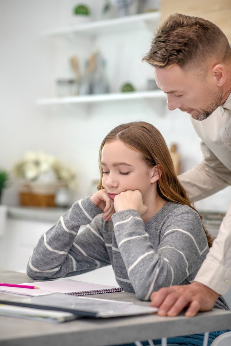 short-haired-man-supporting-his-young-sad-daughter_259150-6479