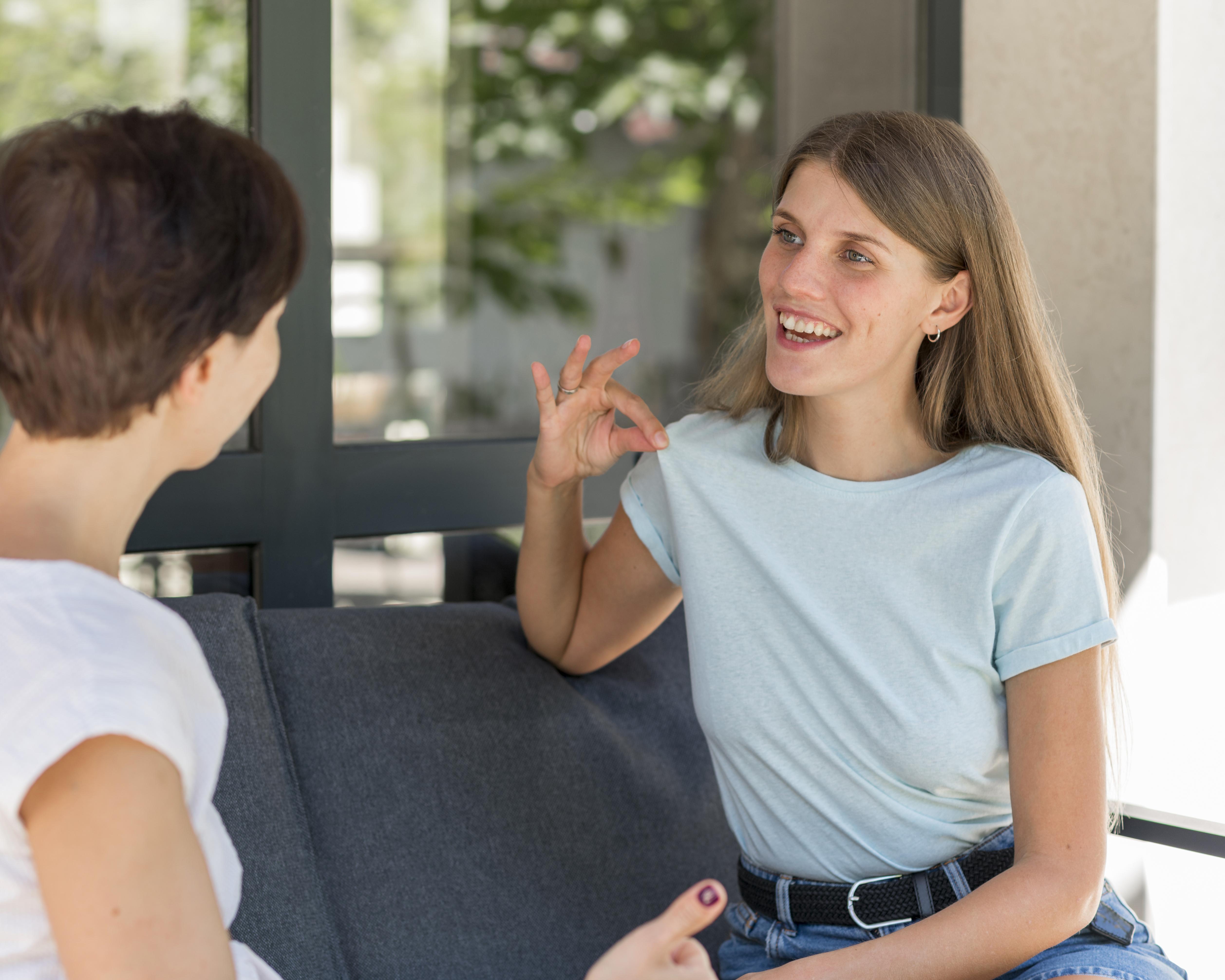two-women-using-sign-language-converse-with-each-other